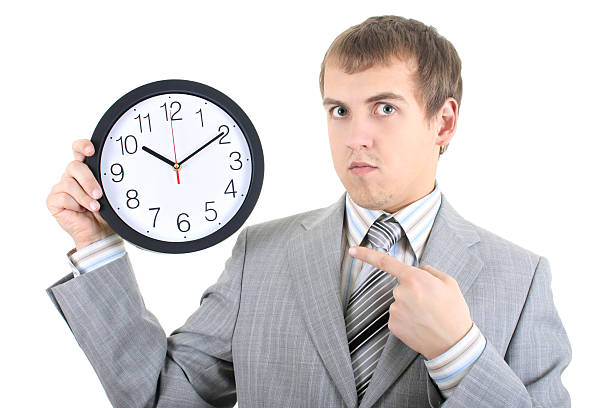 istock young businessman holding a clock 147878085