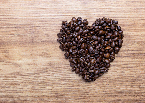 dark Coffee beans in a Heart Shape Isolated on a white background