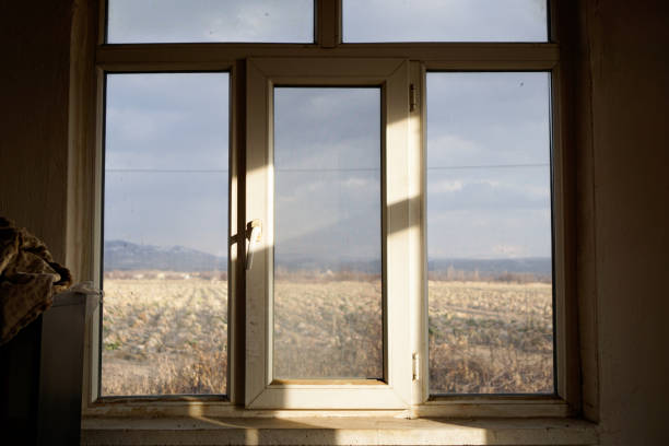 Sunlight and shadows at the white window to the steppe