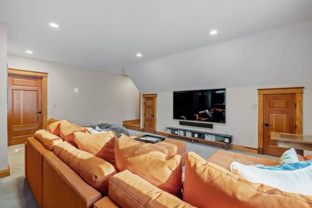 istock Beautiful contemporary rustic home interior den design with brown sofas and a TV 1478784755