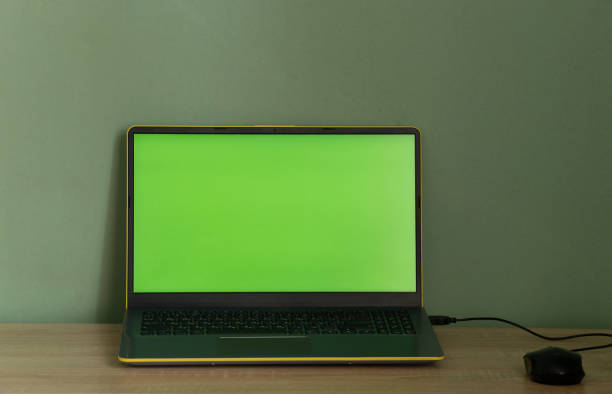 istock laptop with green screen on the table in the room 1478785062