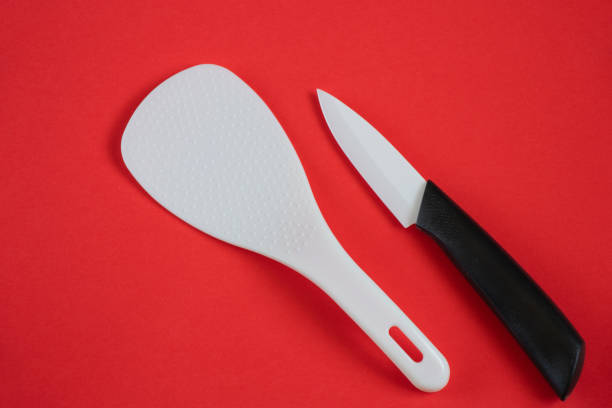 istock ceramic kitchen knife and spoon for multicooker on a red background 1478785116