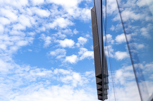 Blue sky and reflection on glass wall of office building