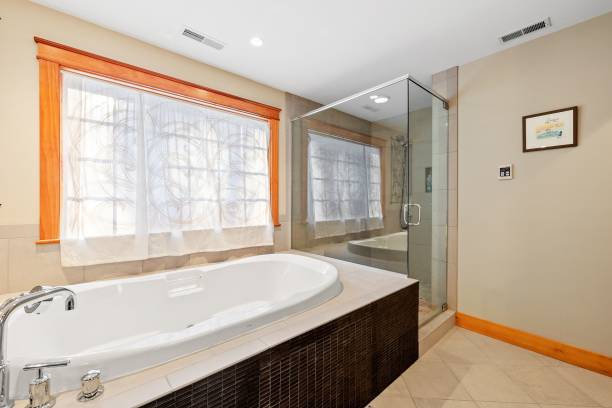 istock Beautiful contemporary rustic home interior bathroom design with a bathtub and windows 1478788297