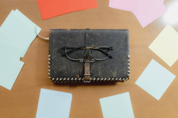 istock Top view of glasses on an old notebook on the table 1478788435