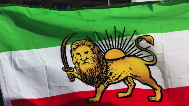 Iran waving pre-revolutionary Lion and Sun flag.
