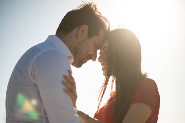 istock Romantic couple hugging outdoor head to head, nice backlight flare effect 1478788900