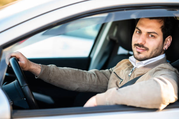 istock Handsome young man in his car. 1478789066