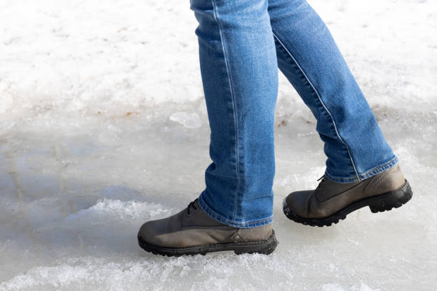 istock man walking on ice in the park. 1478789709