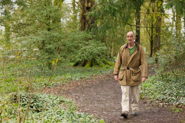 istock Elderly man walking in the woods 1478805911