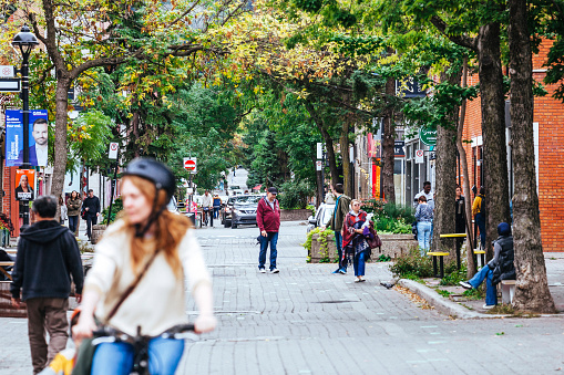 Montreal, Canada - People cycling and walking in Le Plateau district.