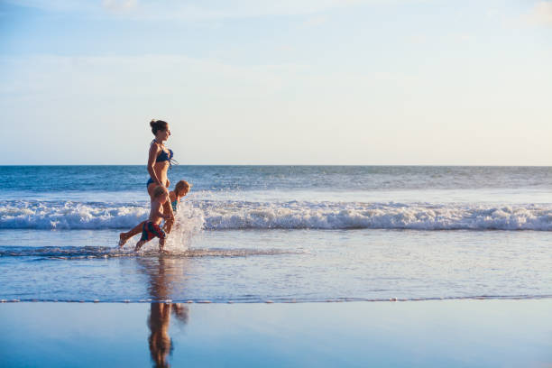 istock Happy mother, kids run with fun by sand beach 1478821736