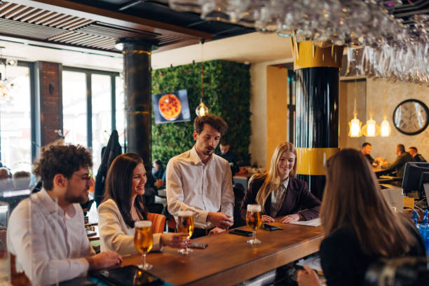 istock Four entrepreneurs drink beer in a bar and enjoy socializing 1478823610