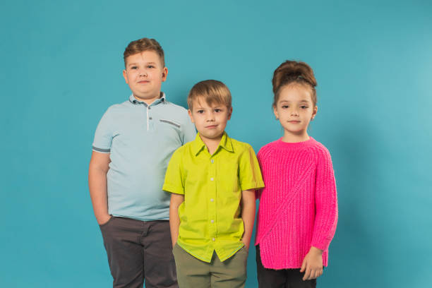 istock Two boys and girl in studio on blue background 1478823862