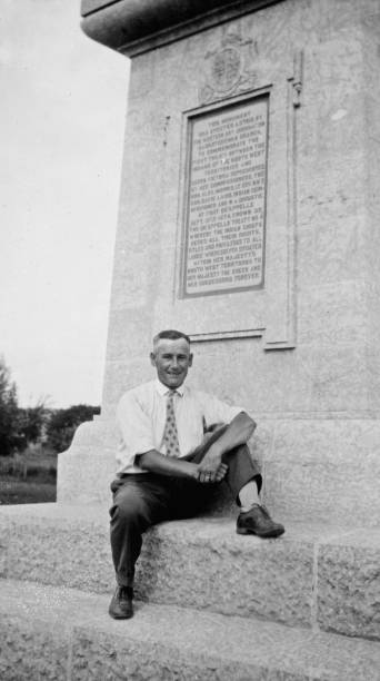 Man by the Treaty 4 Monument at Fort Qu'Appelle in Saskatchewan, Canada  - 1926 Man sitting by the Treaty 4 Monument at Fort Qu'Appelle in Saskatchewan, Canada. Vintage photograph ca. 1926. 1926 stock pictures, royalty-free photos & images