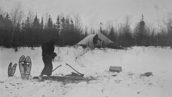 Yakushavich Island, Manitoba, Canada - March 1928. Men in a geological survey camp at Yakushavich Island on Kississing Lake in Manitoba, Canada. Vintage photograph ca. 1928.