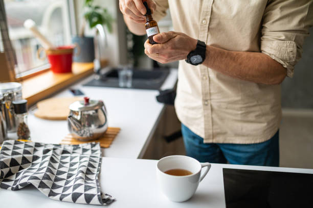istock Man holding CBD oil 1478838016