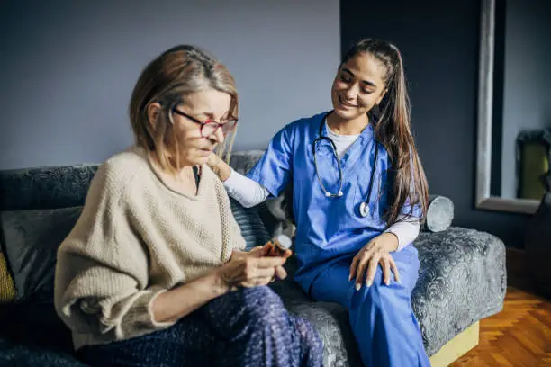 Photo of A nurse talking to a patient during a home visit