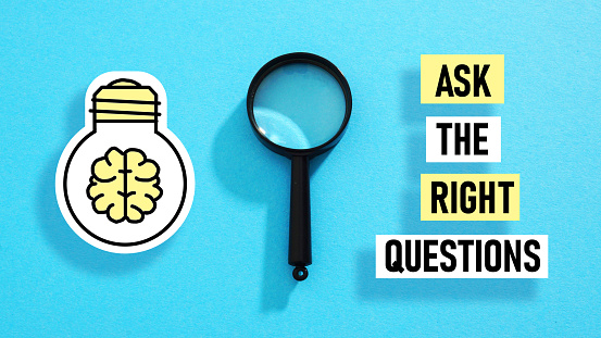 Ask the right questions is shown using a text and photo of magnifying glass