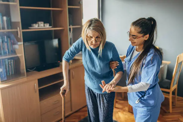 Photo of A nurse is helping a female senior patient to walk