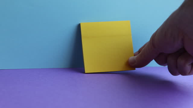 Blank adhesive paper on colored background