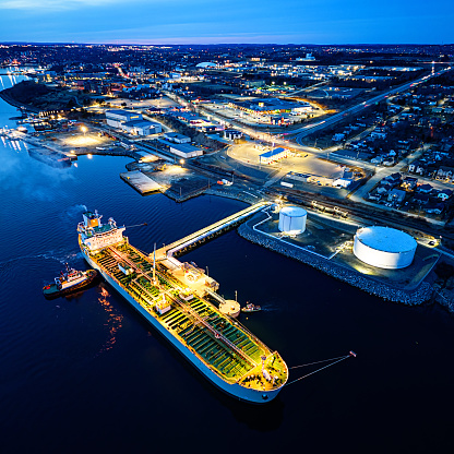 Aerial view of an oil/chemical tanker ship docked at port in twilight.