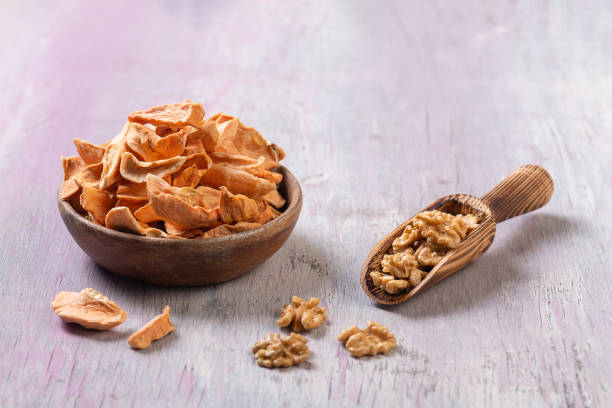istock Dried apricots and walnuts in wooden containers 1478868014