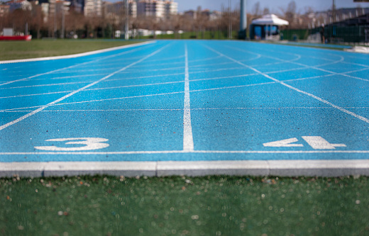 Blue running track with numbers 3 and 4 on it