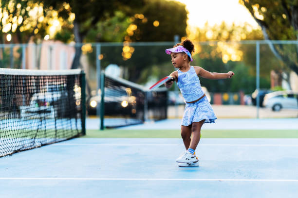 istock A young Hispanic player focuses on improving her serve during a pickleball practice session, determined to perfect her skills. 1478877740