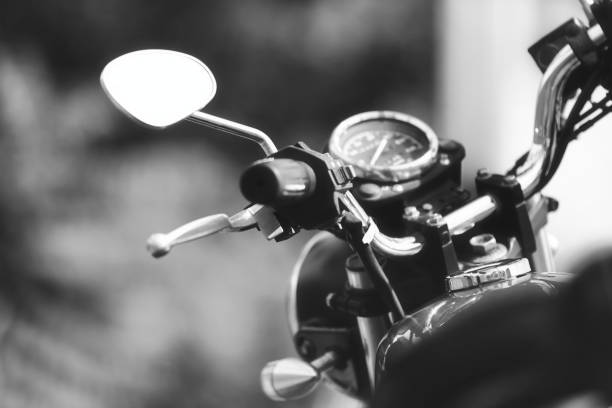 Black and white closeup motorcycle turn signal light and headlight, background with copy space, full frame horizontal composition
