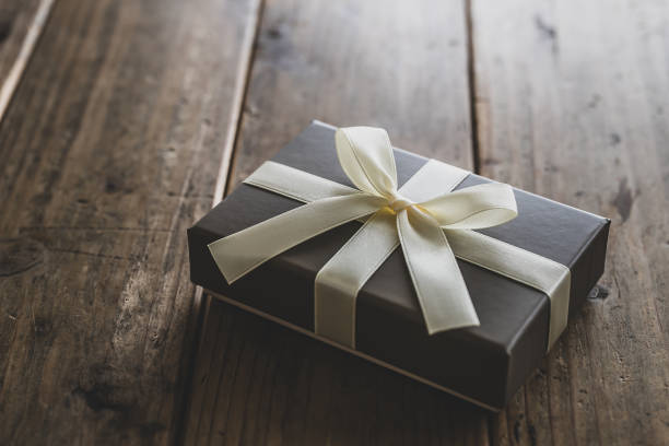 istock Brown present box on natural wood background. 1478893427