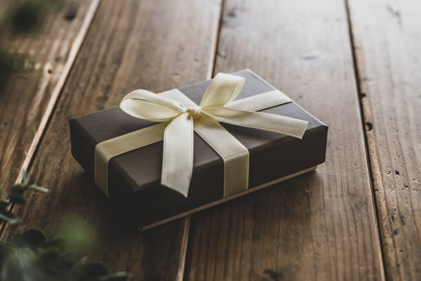 istock Brown present box on natural wood background. 1478893431