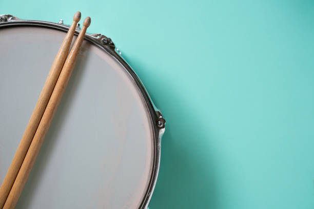 istock Drum stick and drum on green table background, top view, music concept 1478897884