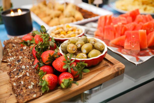 istock elegantly arranged charcuterie board displaying various meats, cheeses, fruits, and nuts. It symbolizes the joy of abundance and shared experiences, emphasizing the importance of enjoying life 1478898268