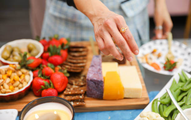 istock elegantly arranged charcuterie board displaying various meats, cheeses, fruits, and nuts. It symbolizes the joy of abundance and shared experiences, emphasizing the importance of enjoying life 1478899207