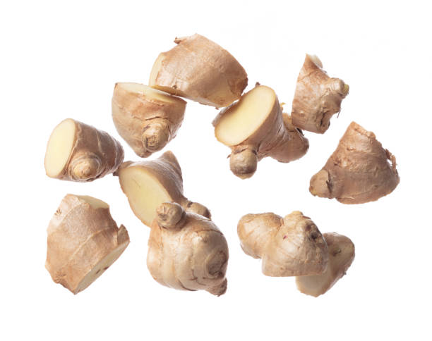 istock Ginger fall fly in mid air, fresh vegetable spice ginger falling. Organic fresh herbal ginger root head cut chop slice, close up texture. White background isolated freeze motion high speed shutter 1478902683