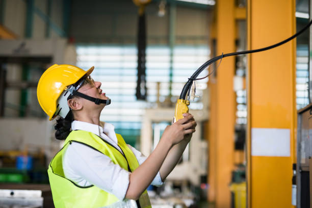 istock Factory female worker use remote control to lift crane 1478909454