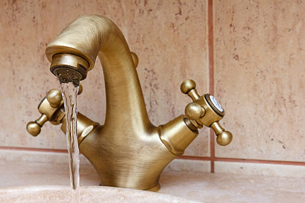 istock Water flowing from vintage or retro faucet 147890987