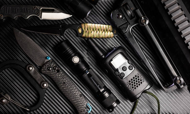 istock Tactical black EDC gear on carbon fiber 1478911099