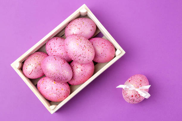 istock Easter. Pink Easter eggs in a box on a trendy lilac background. Happy easter. holidays. top view 1478913600