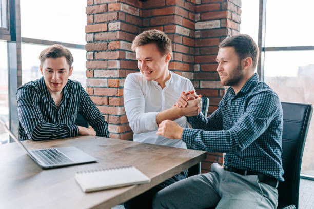 istock Three men using their laptops to improve their productivity and success at work 1478913856