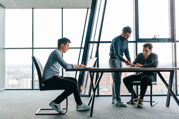 istock A male mentor offering guidance to a trainee on how to complete a work task 1478913860