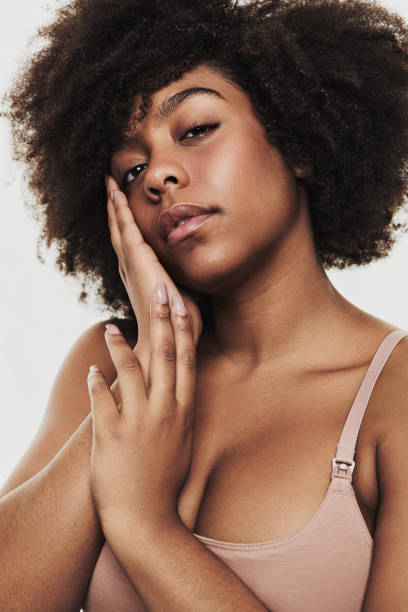istock Alluring black woman touching cheek and looking at camera 1478914072