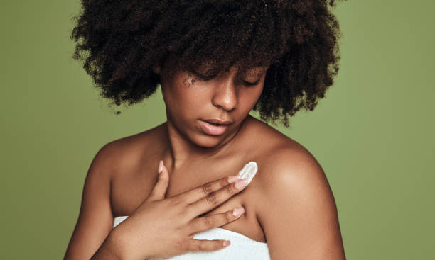 istock Black woman smearing cream on shoulder 1478914163