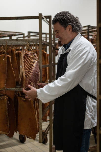 istock Meat production worker in a meat drying plant 1478916189
