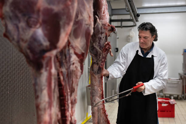 istock Butcher in the butcher's cold room. 1478916231