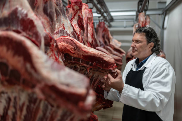 istock Butcher in the butcher's cold room. 1478916244