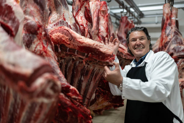 istock Butcher in the butcher's cold room. 1478916252