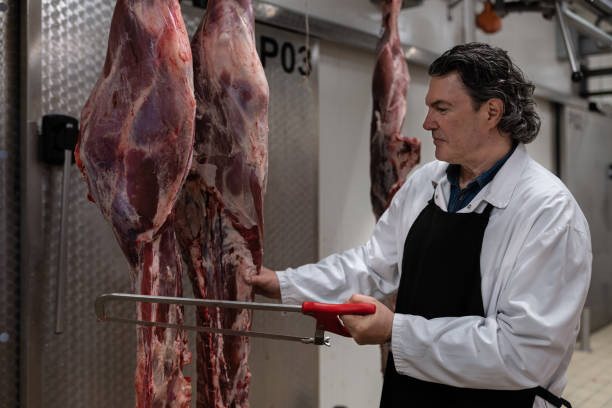 istock Butcher in the butcher's cold room. 1478916266