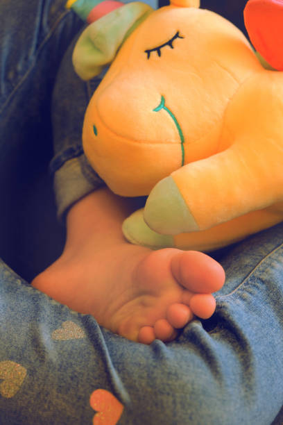 istock Barefoot, relaxing with toy. Lazy holiday concept 1478917654